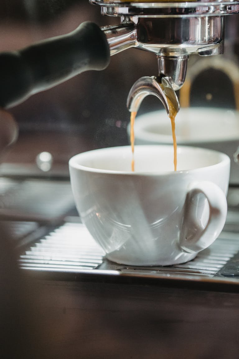 Best home espresso machines – five espresso machines on a kitchen counter with coffee mugs and accessories