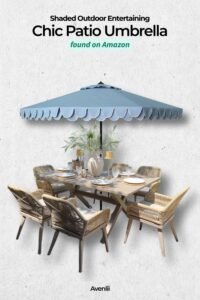 Blue scalloped patio umbrella shading an outdoor dining table with wicker chairs and table decor, creating a stylish backyard entertaining setup.